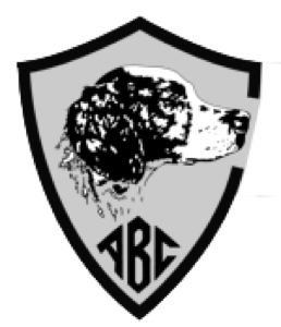A shield emblem featuring a black and white illustration of a dog's head in profile, with the letters "ABC" below.