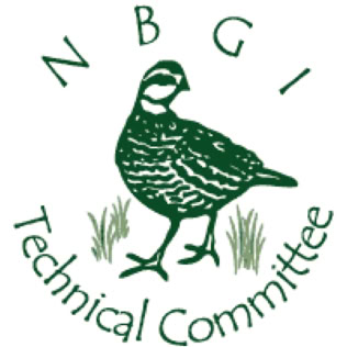 A woman and a man are attending to a dog on a table in a room with white cabinets and shelves.